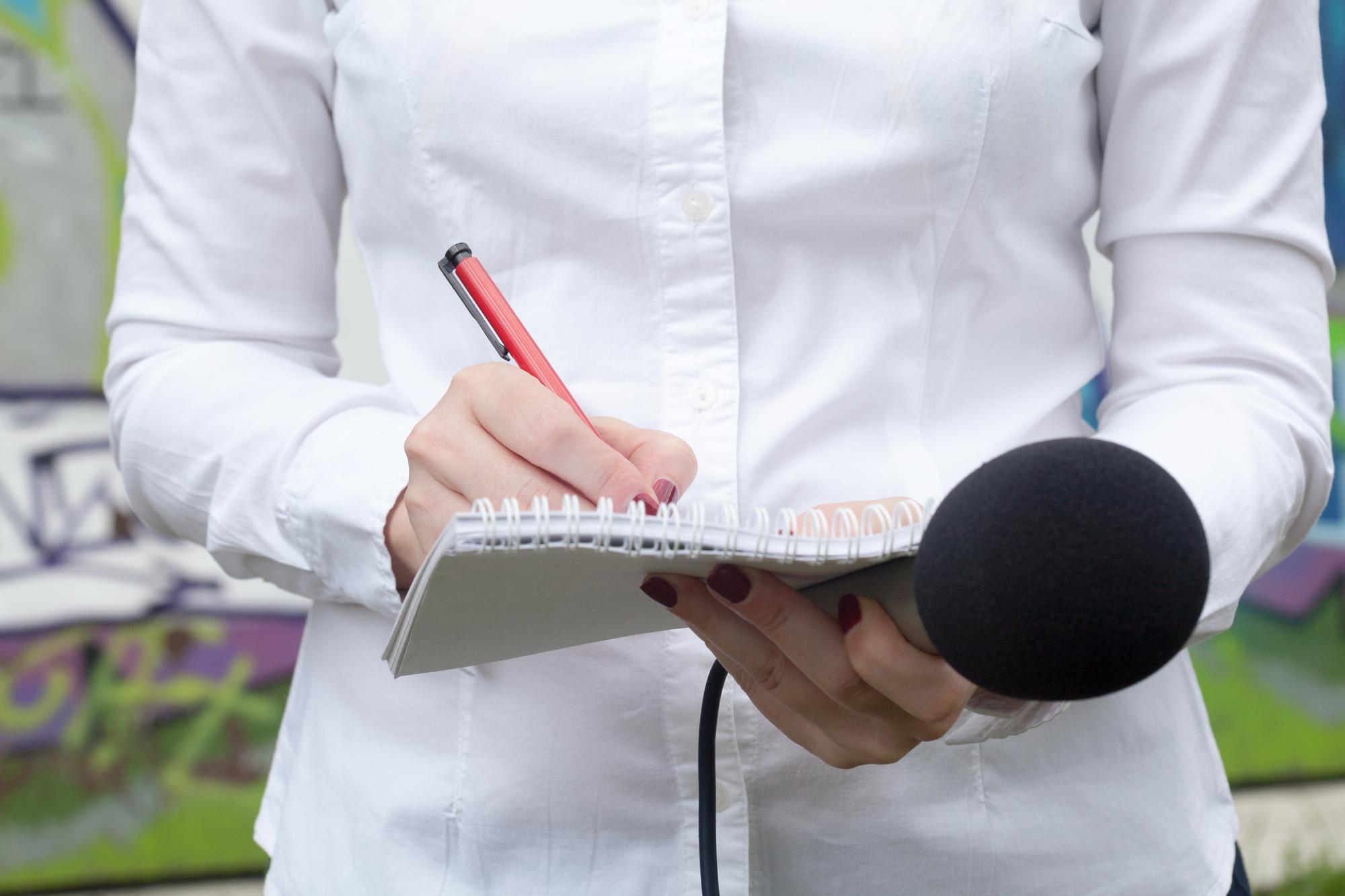 Reporter taking notes during an interview
